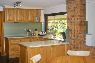 Solid American Oak Timber Kitchen with Granite Tops and Alfresco Window by Compass Kitchens at Blackwood