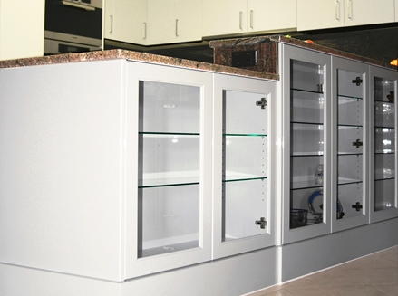 Clever storage and display cabinetry by Compass KItchens